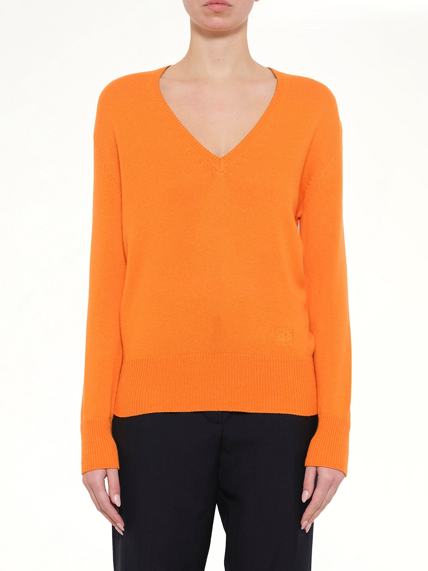 Image of a model wearing Outerwear. Product name - V Neck Sweater in Orange colour by brand - LOEWE