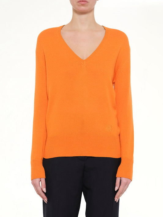 Image of a model wearing Outerwear. Product name - V Neck Sweater in Orange colour by brand - LOEWE