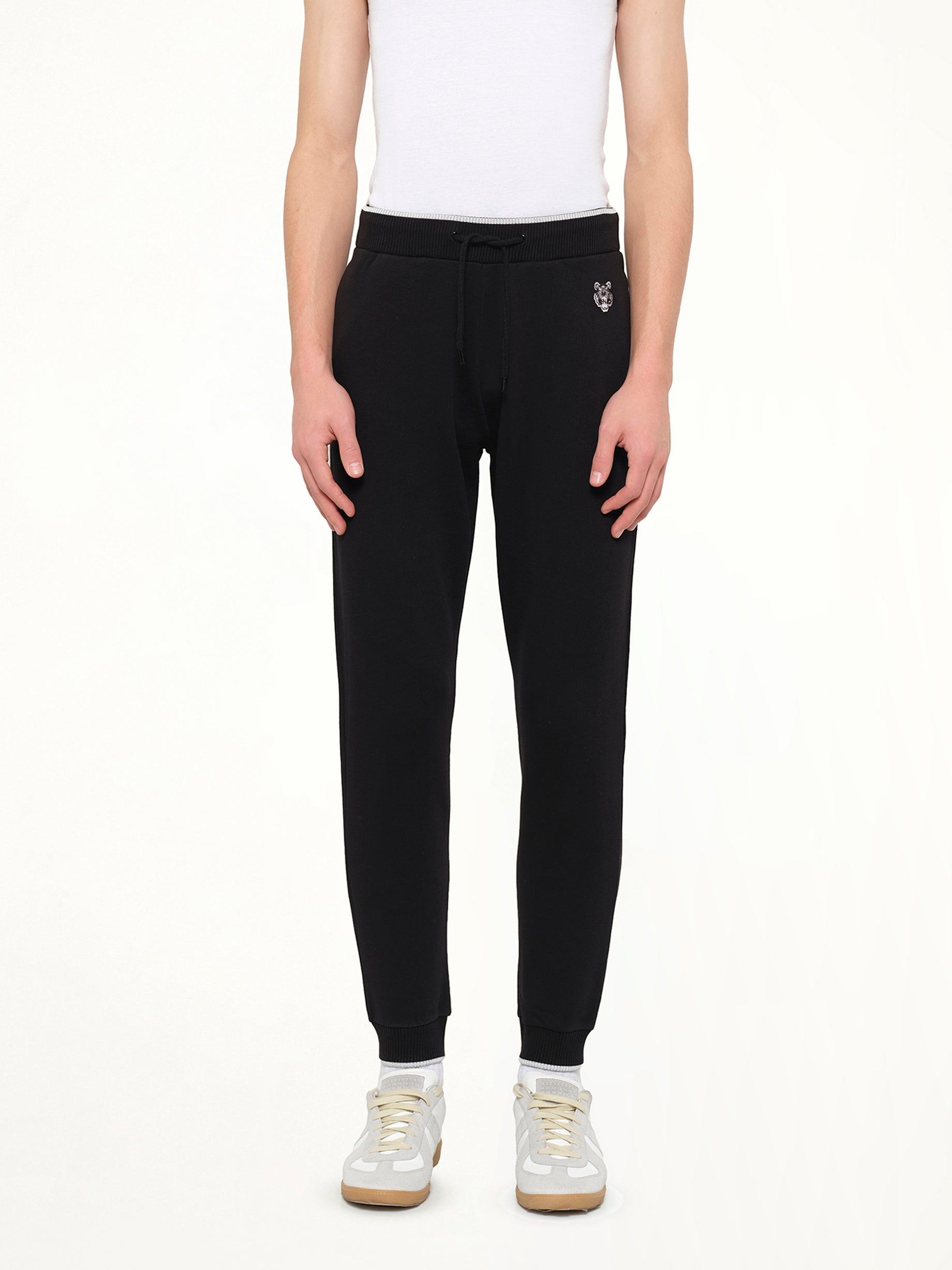 Image of a model wearing Pants. Product name - Kenzo Casual Pants in Black colour by brand - KENZO