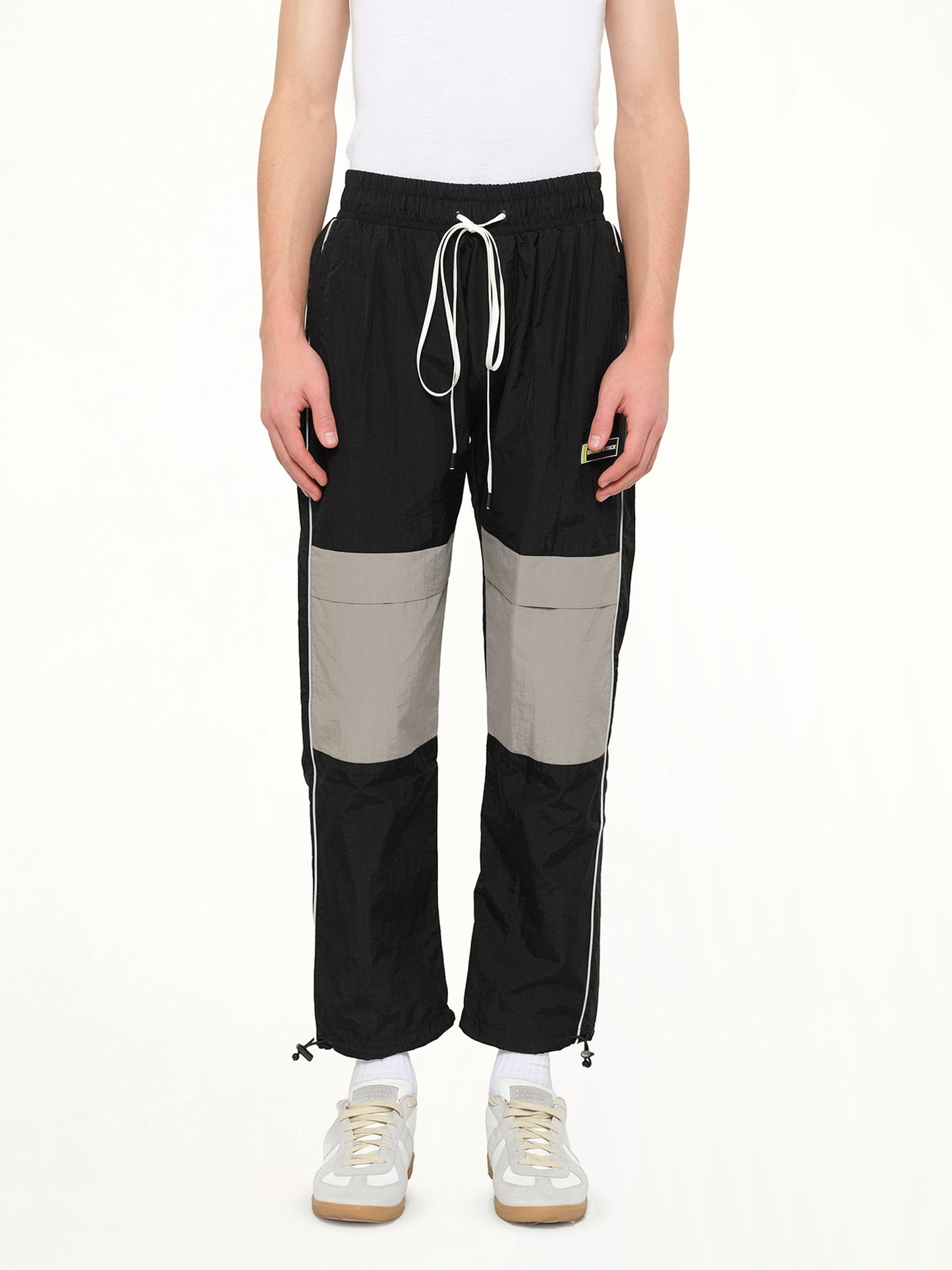 Image of a model wearing Pants. Product name - Parachute Pant in Black colour by brand - DANIEL PATRICK