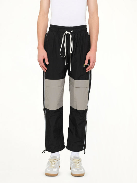 Image of a model wearing Pants. Product name - Parachute Pant in Black colour by brand - DANIEL PATRICK
