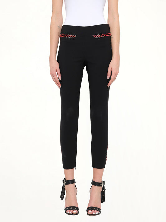 Image of a model wearing Pants. Product name - Alexander McQueen Leather Trousers in Black colour by brand - ALEXANDER MCQUEEN