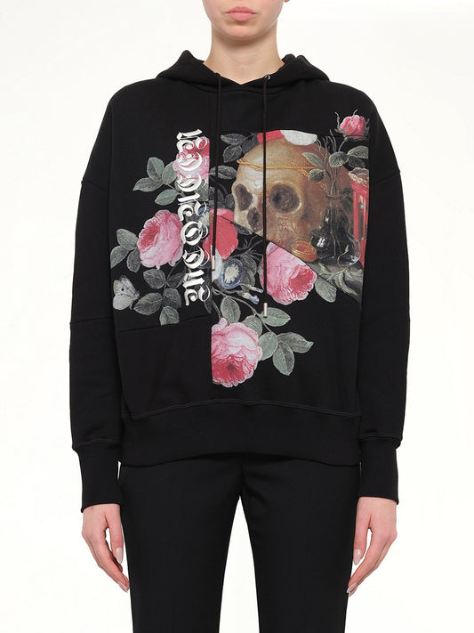 Image of a model wearing Outerwear. Product name - Alexander McQueen Skull Rose Embellished Hoodie in Black colour by brand - ALEXANDER MCQUEEN
