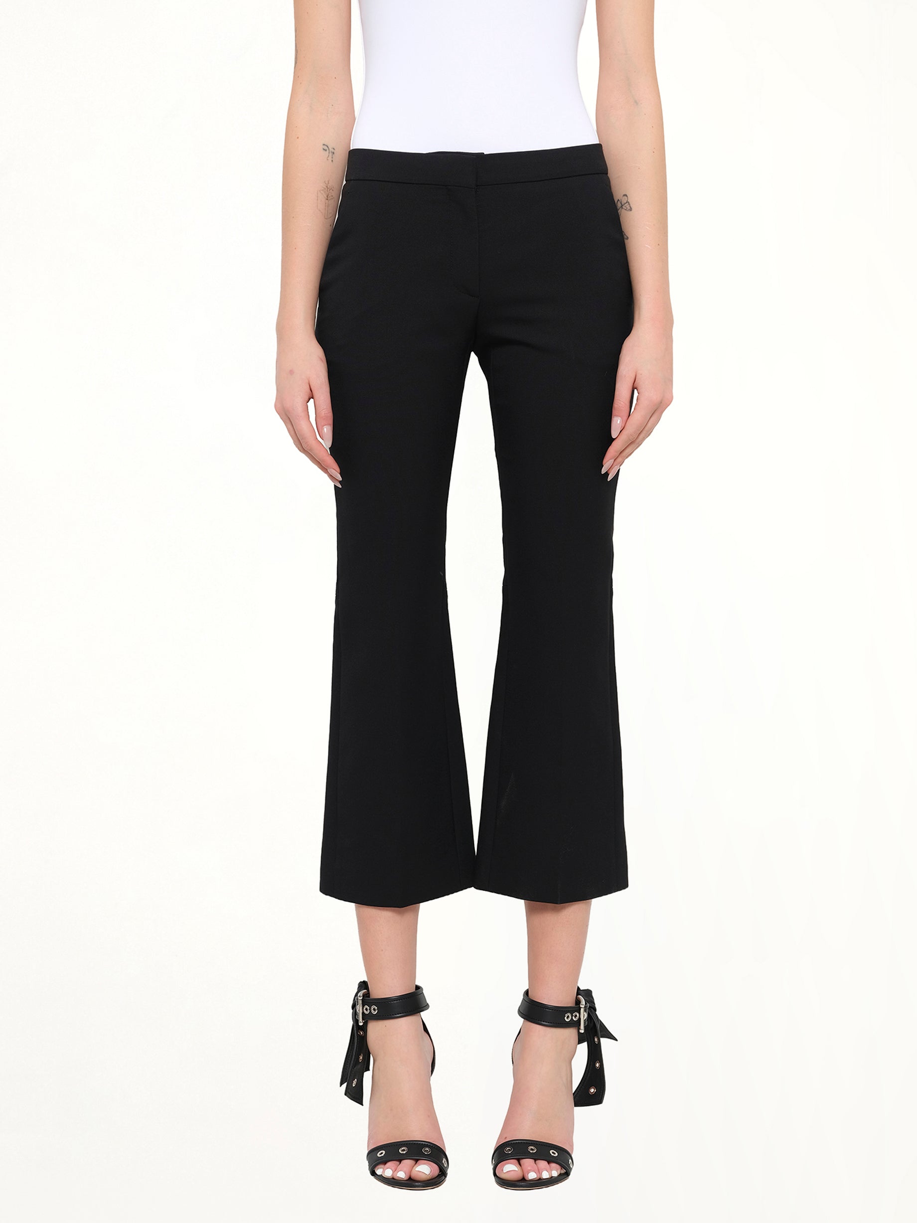 Image of a model wearing Pants. Product name - Kickbacks Pant in Black colour by brand - ALEXANDER MCQUEEN