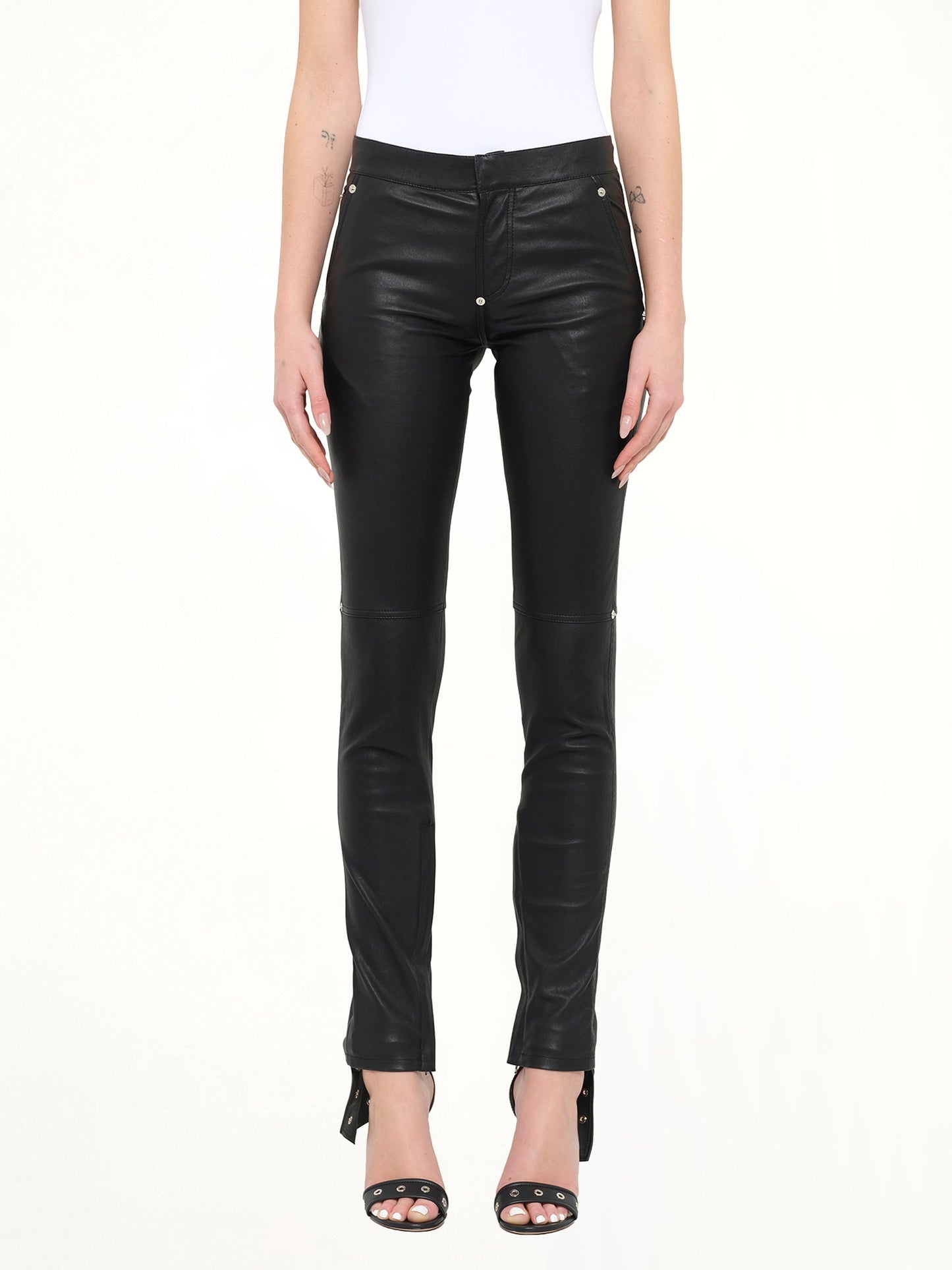 Image of a model wearing Pants. Product name - Givenchy Leather Trousers in Black colour by brand - GIVENCHY