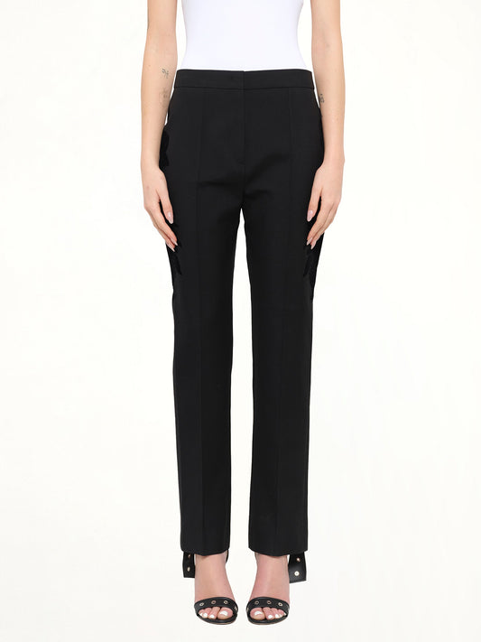 Image of a model wearing Pants. Product name - Givenchy Podium Trousers in Black colour by brand - GIVENCHY