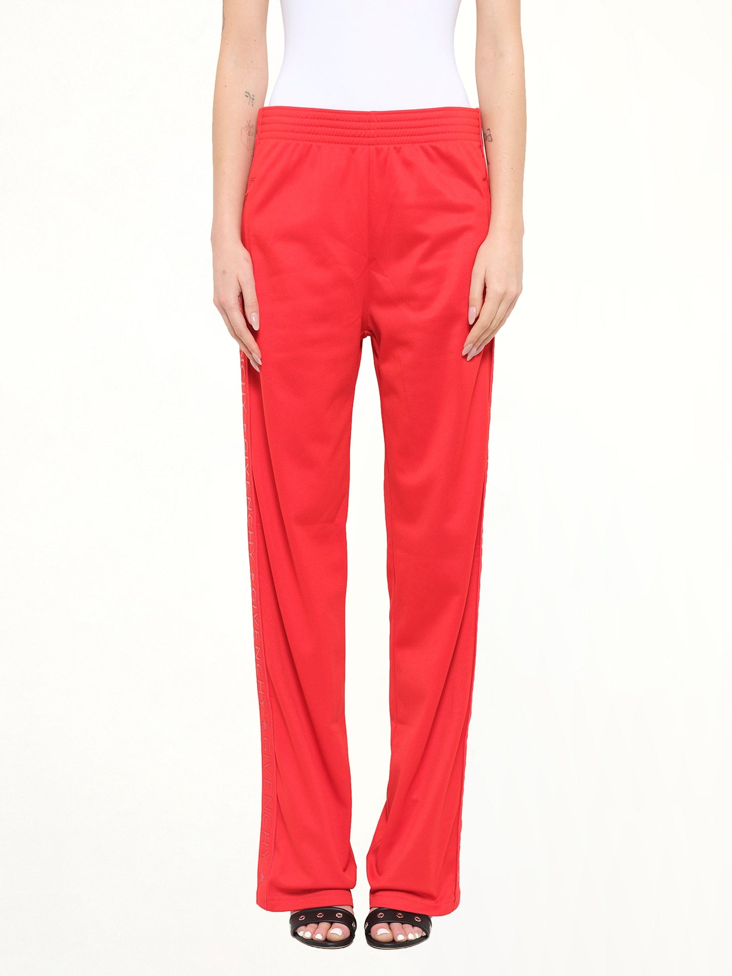 Image of a model wearing Pants. Product name - Givenchy Podium Trousers in Red colour by brand - GIVENCHY