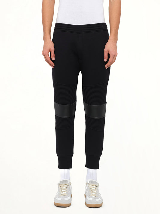 Image of a model wearing Pants. Product name - Neil Barrett Knit Pants in Black colour by brand - NEIL BARRETT