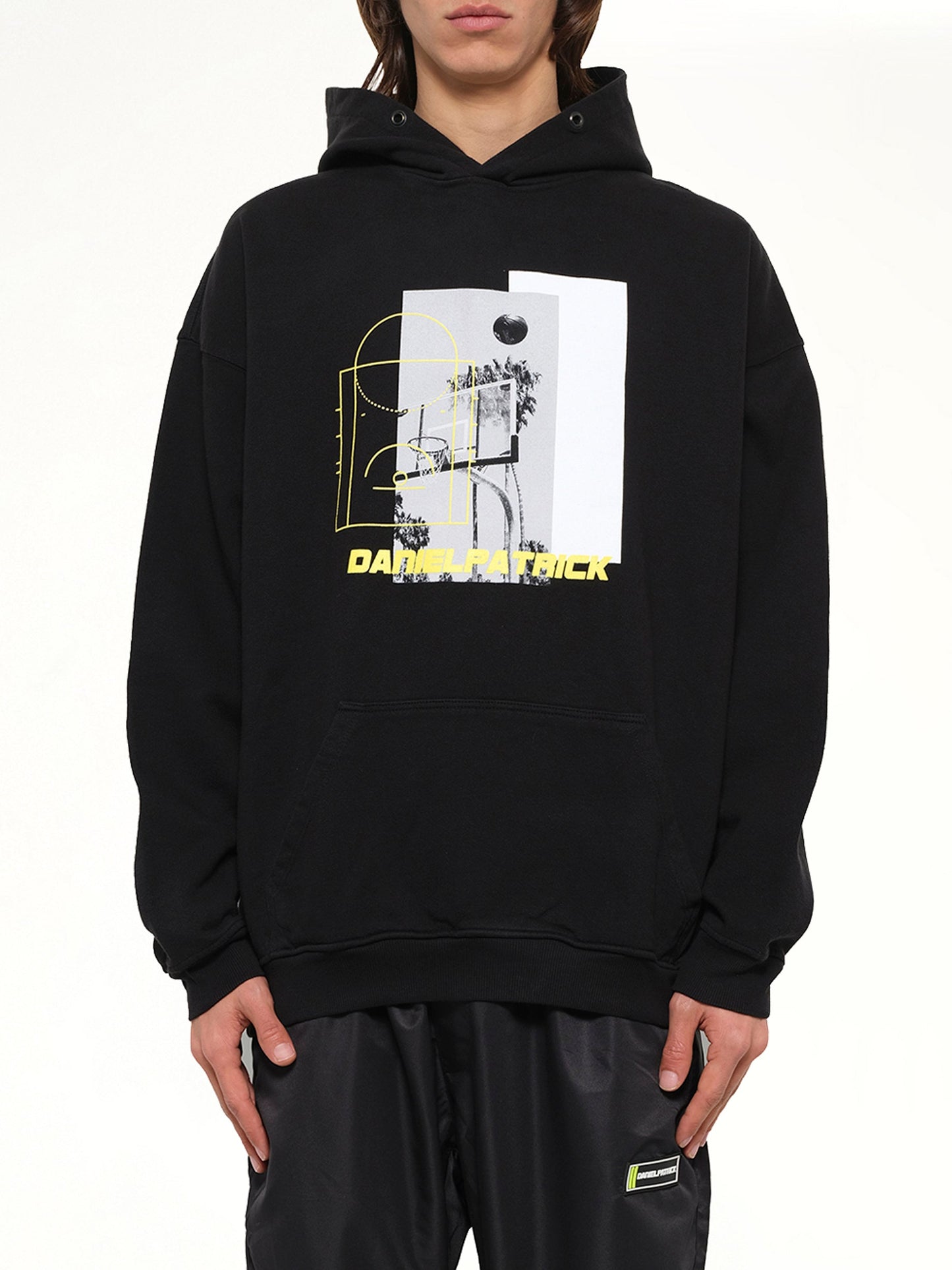 Image of a model wearing Outerwear. Product name - 94 B-Ball Hoodie in Black colour by brand - DANIEL PATRICK