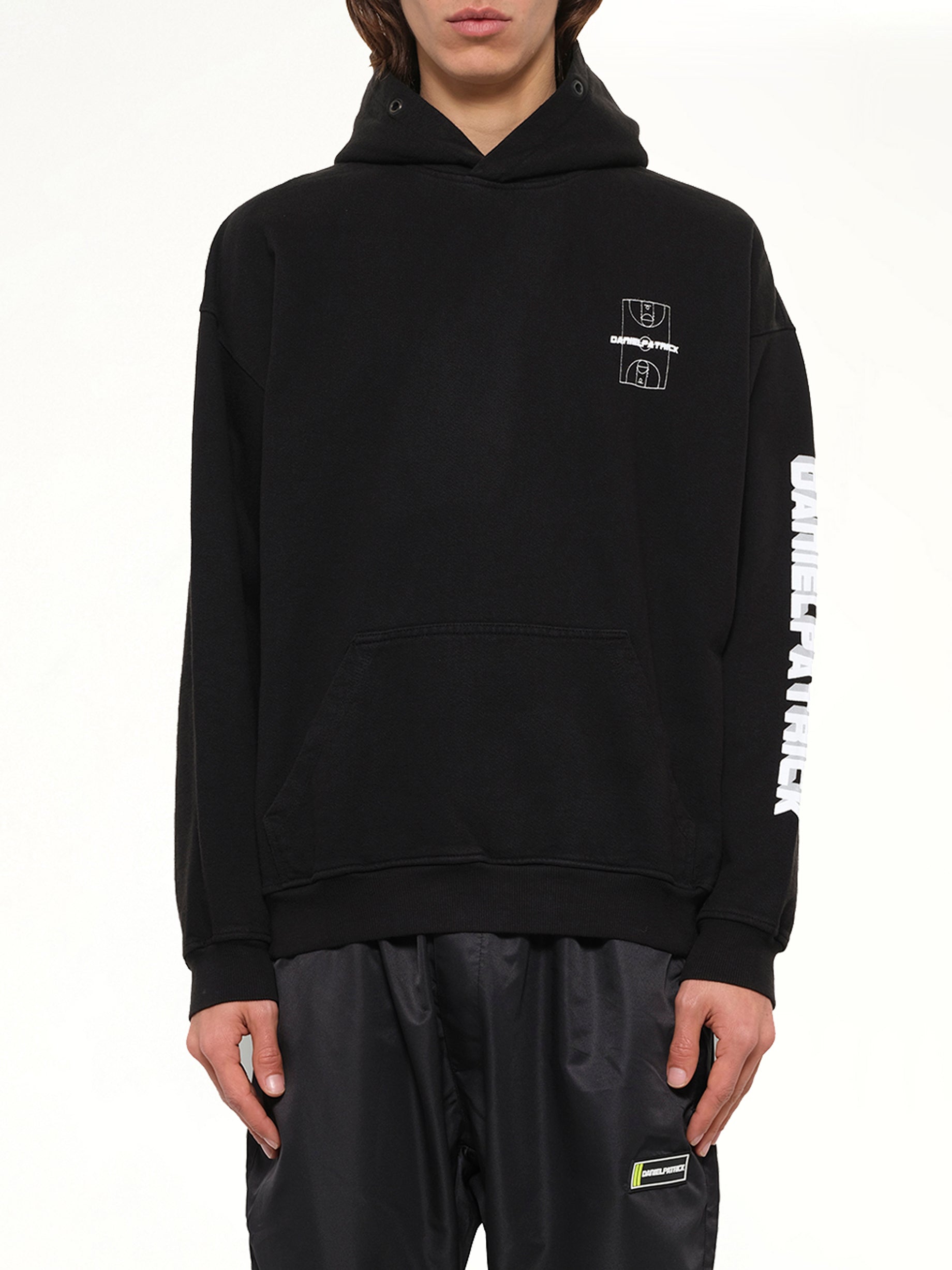 Image of a model wearing Outerwear. Product name - DP Court Hoodie in Black colour by brand - DANIEL PATRICK