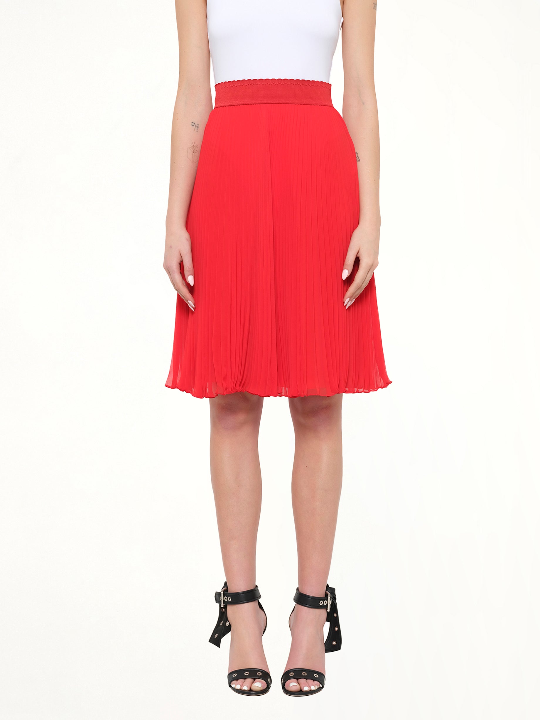 Image of a model wearing Skirts. Product name - Givenchy Pleated Skirt in Red colour by brand - GIVENCHY