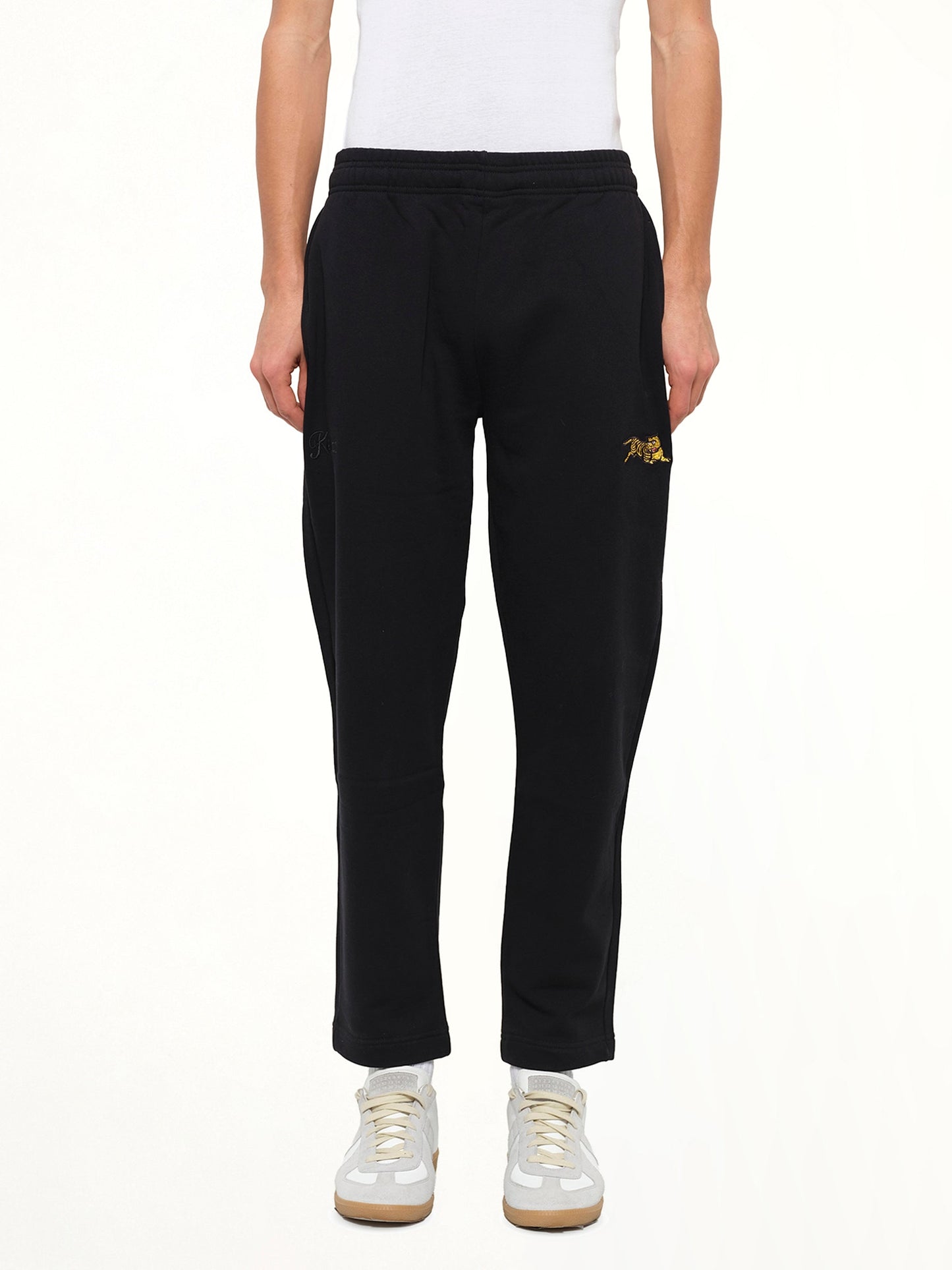 Image of a model wearing Pants. Product name - Jumping Tiger Pant in Black colour by brand - KENZO