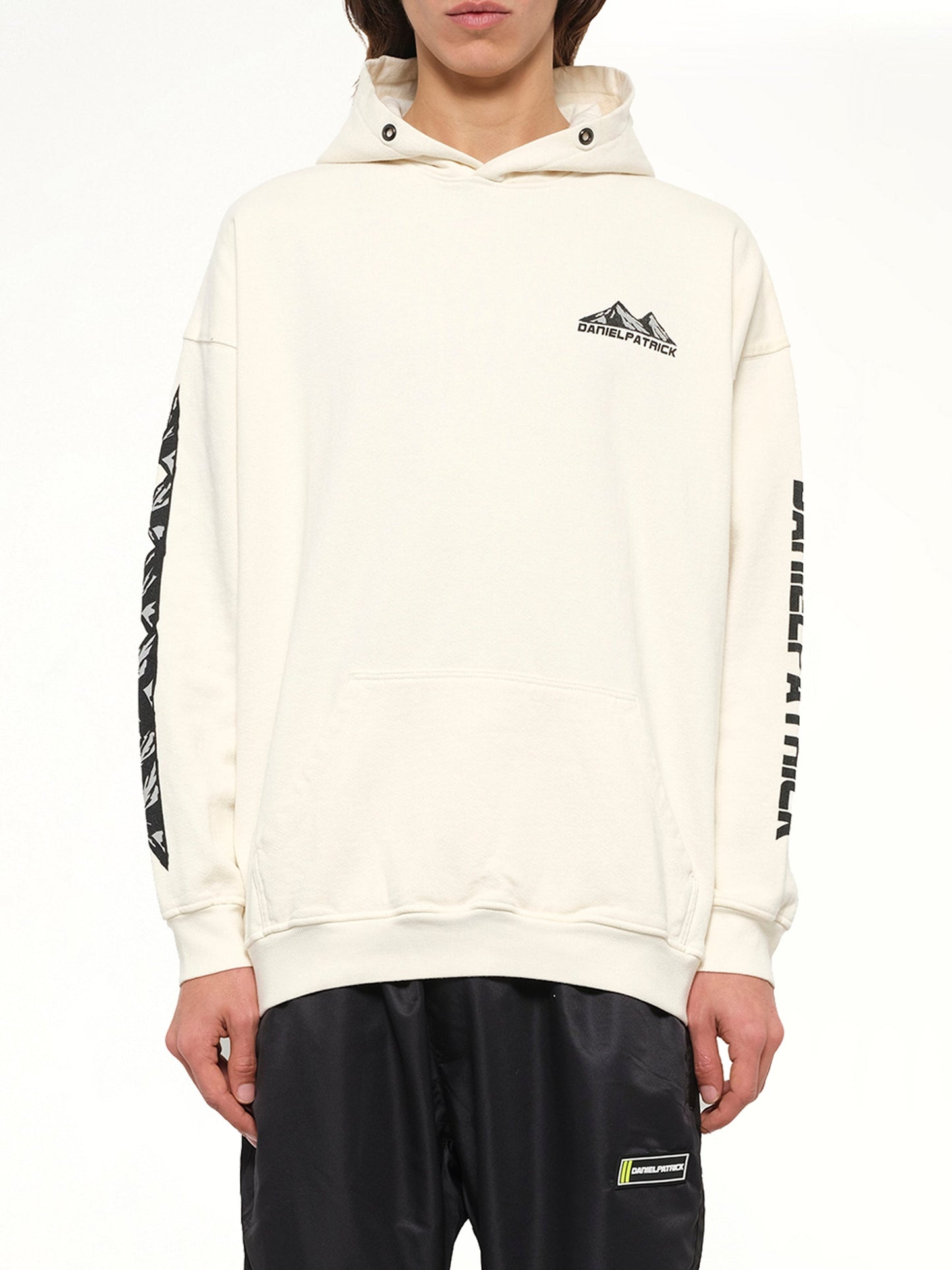 Image of a model wearing Outerwear. Product name - Moving Mountains Hoodie in White colour by brand - DANIEL PATRICK