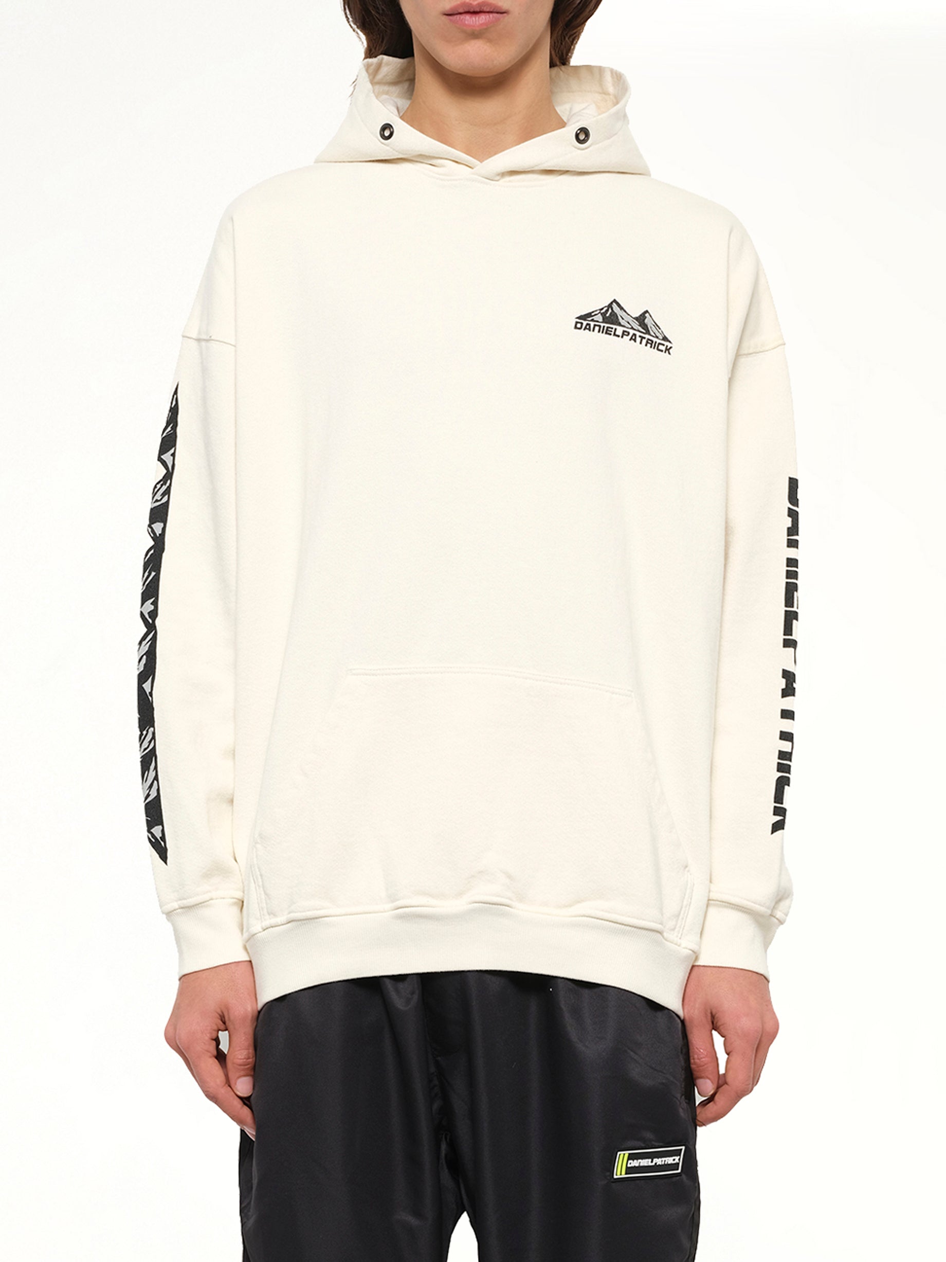 Image of a model wearing Outerwear. Product name - Moving Mountains Hoodie in White colour by brand - DANIEL PATRICK