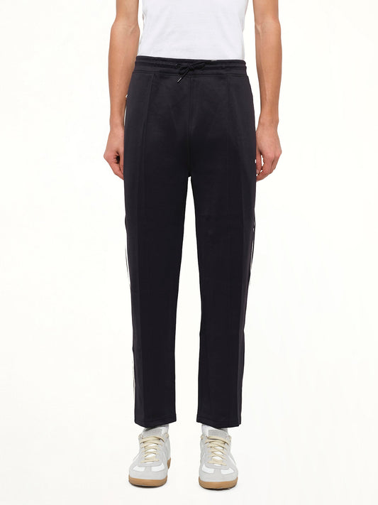 Image of a model wearing Pants. Product name - Neoprene Pants in Black colour by brand - KENZO