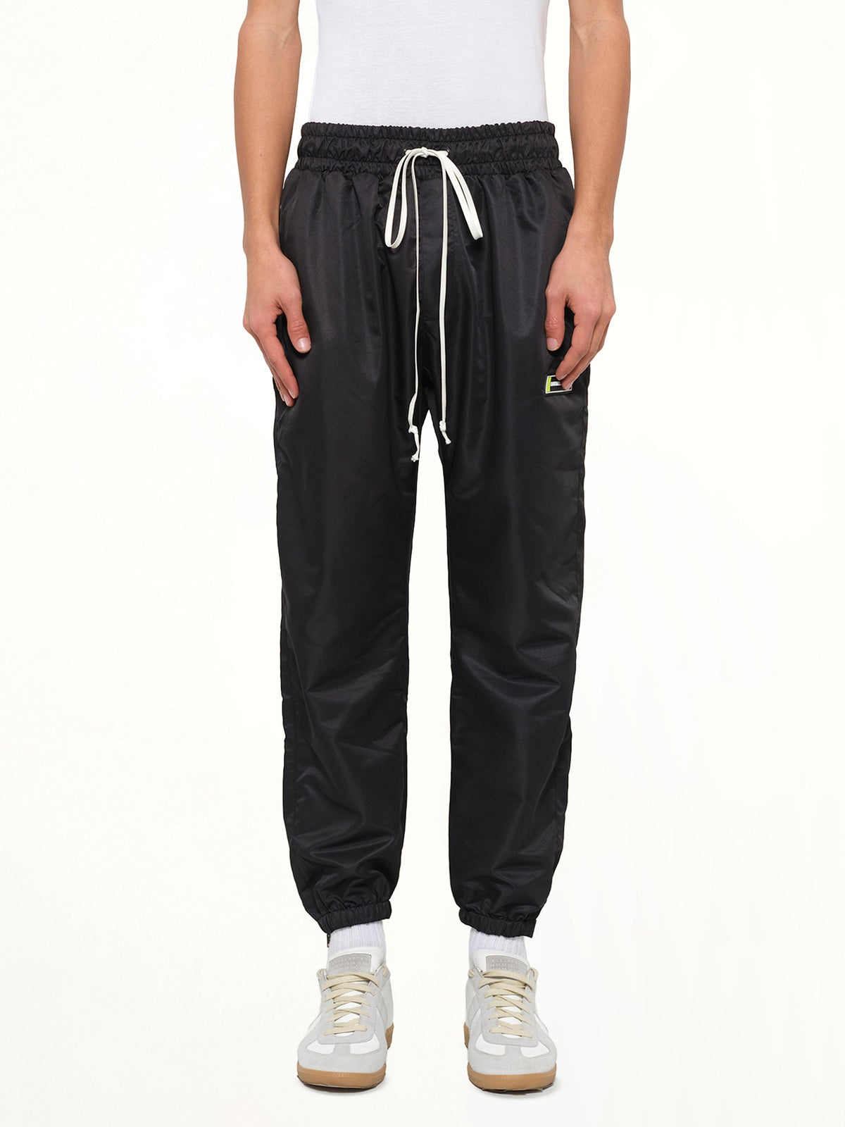 Image of a model wearing Pants. Product name - Parachute Track Pant in Black colour by brand - DANIEL PATRICK