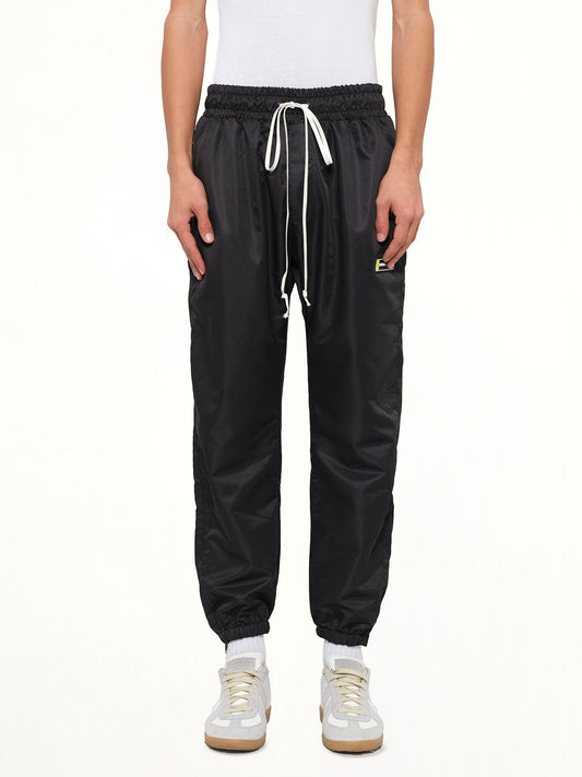Image of a model wearing Pants. Product name - Parachute Track Pant in Black colour by brand - DANIEL PATRICK