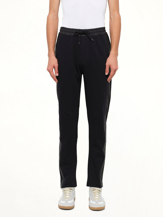 Image of a model wearing Pants. Product name - Stripe Jog Pant in Black colour by brand - KENZO