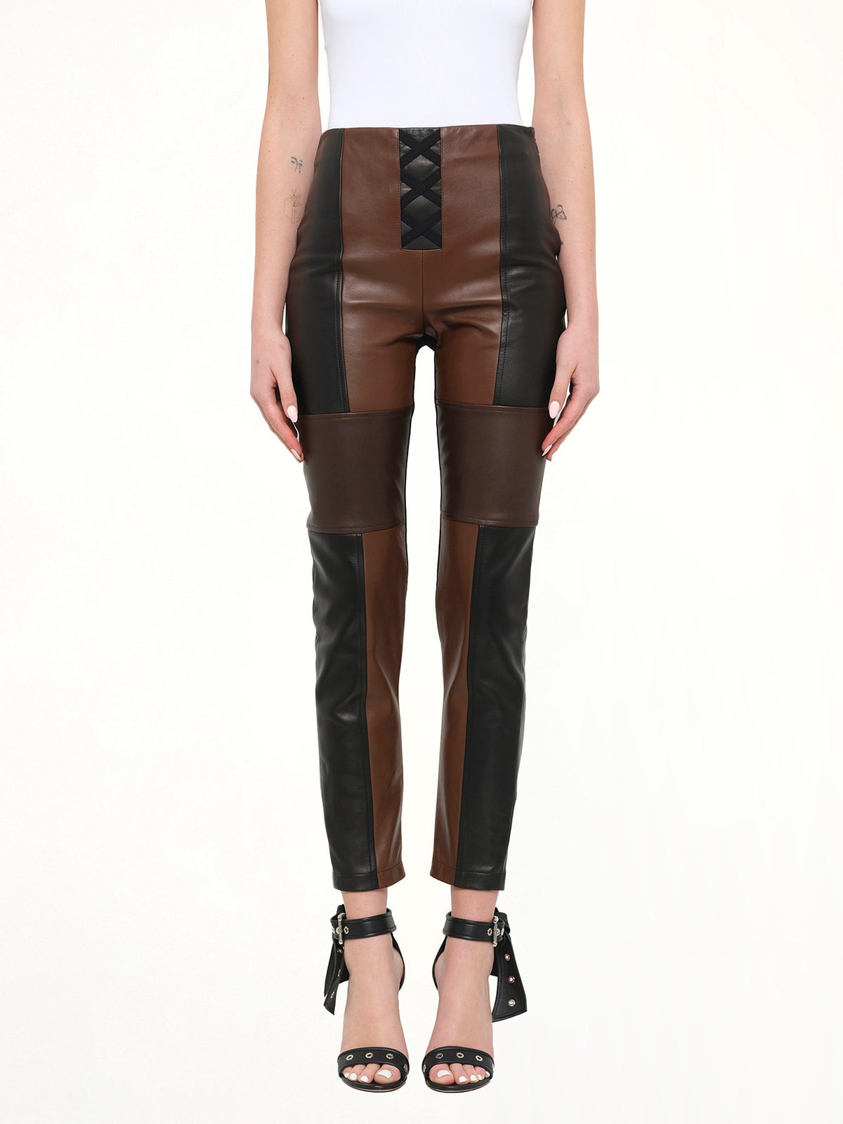 Image of a model wearing Pants. Product name - Neil Barrett Leather Pants in Black colour by brand - NEIL BARRETT