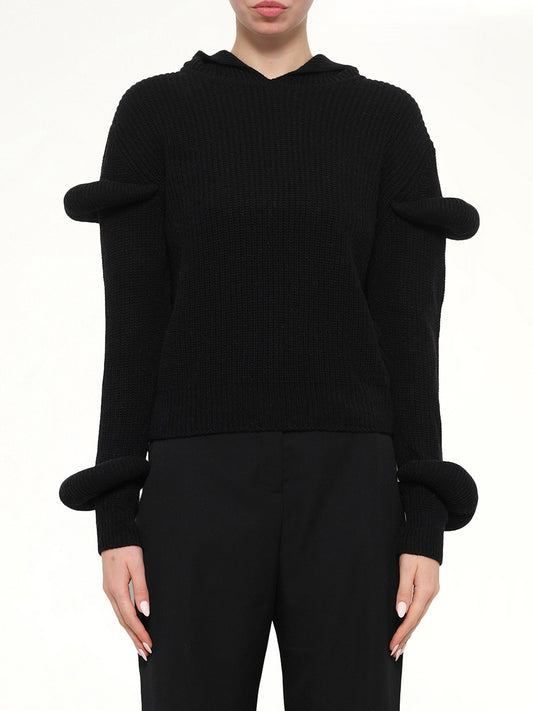 Image of a model wearing Outerwear. Product name - Rib Knit Hoodie in Black colour by brand - JWA