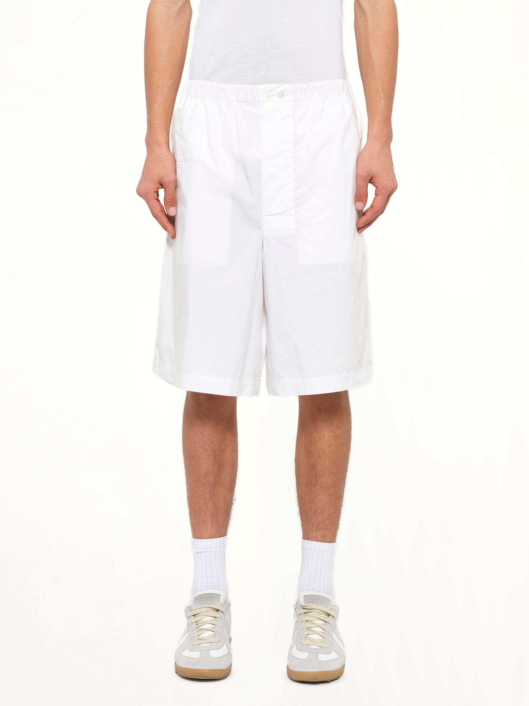 Image of a model wearing Shorts. Product name - Loewe Shorts in White colour by brand - LOEWE