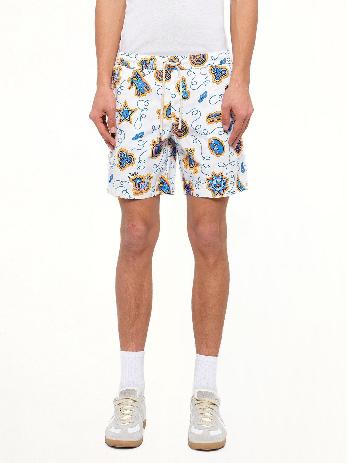 Image of a model wearing Shorts. Product name - Loewe x Paula Printed Swim Shorts in White colour by brand - LOEWE