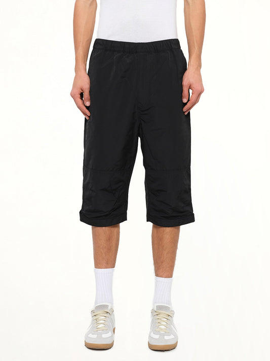 Image of a model wearing Shorts. Product name - Long Stretch Waist Shorts in Black colour by brand - GIVENCHY