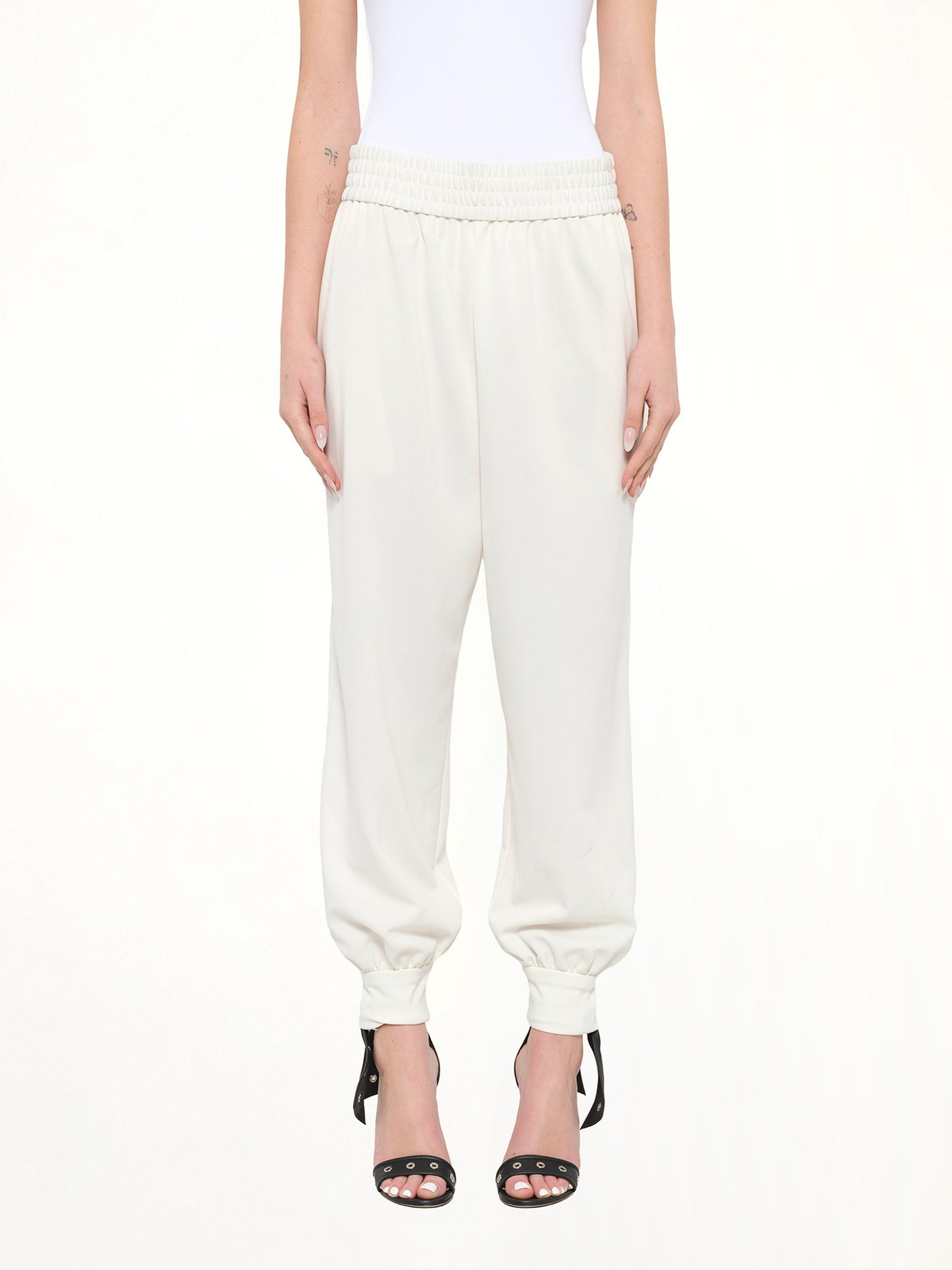 Image of a model wearing Pants. Product name - Jogger Pant in White colour by brand - MARC JACOBS