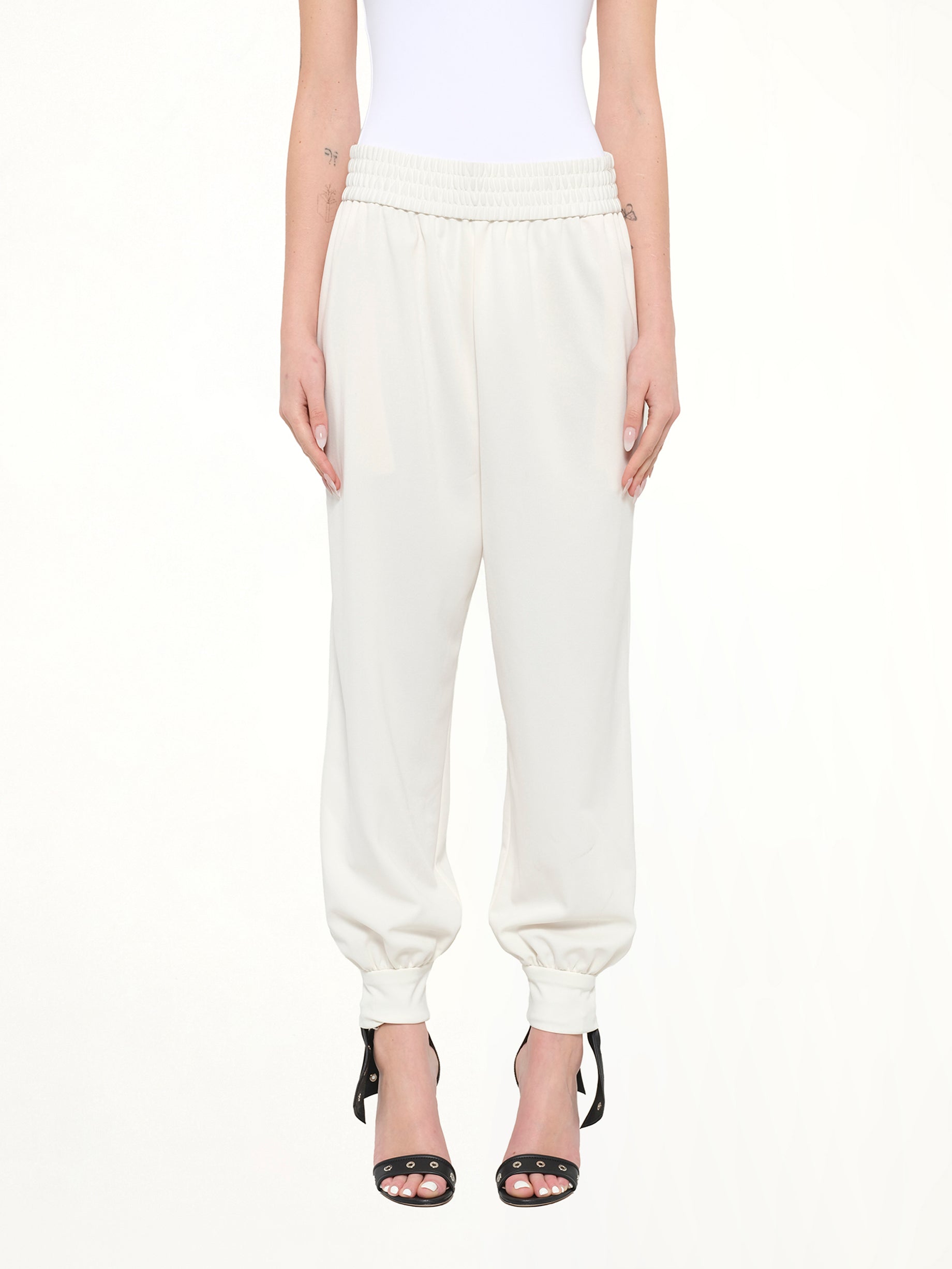 Image of a model wearing Pants. Product name - Jogger Pant in White colour by brand - MARC JACOBS