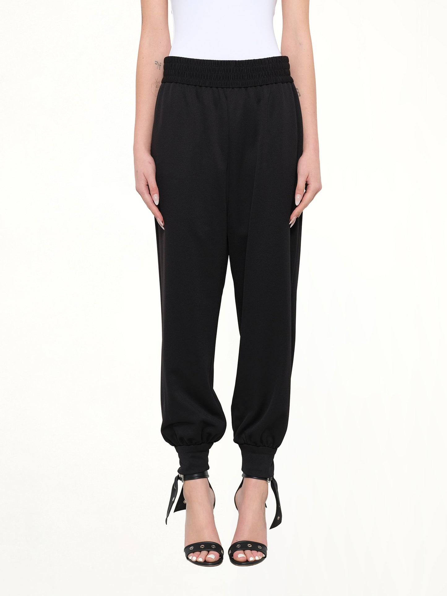 Image of a model wearing Pants. Product name - Marc Jacobs Jogger Pant in Black colour by brand - MARC JACOBS