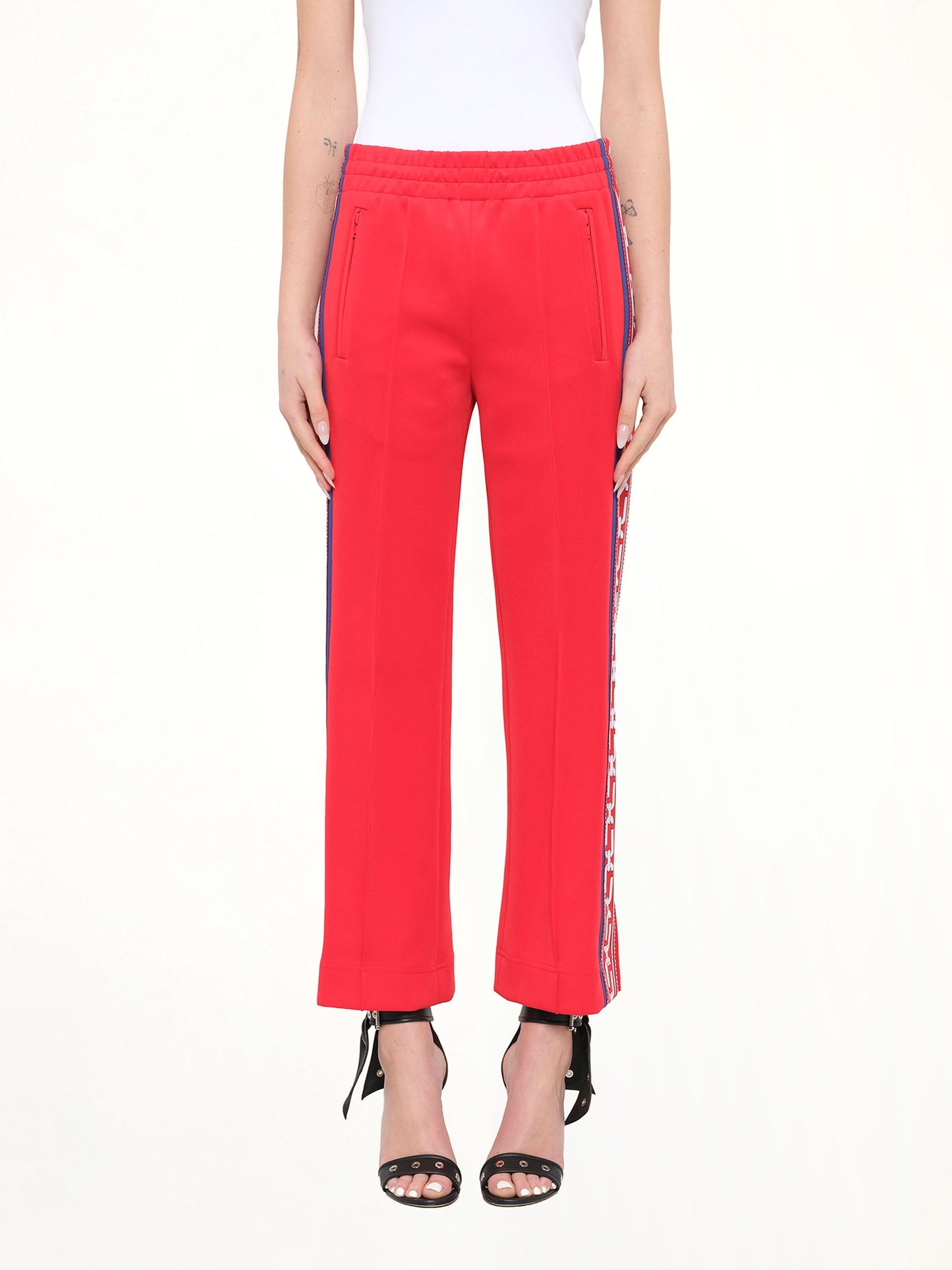 Image of a model wearing Pants. Product name - Marc Jacobs Track Pants in Red colour by brand - MARC JACOBS
