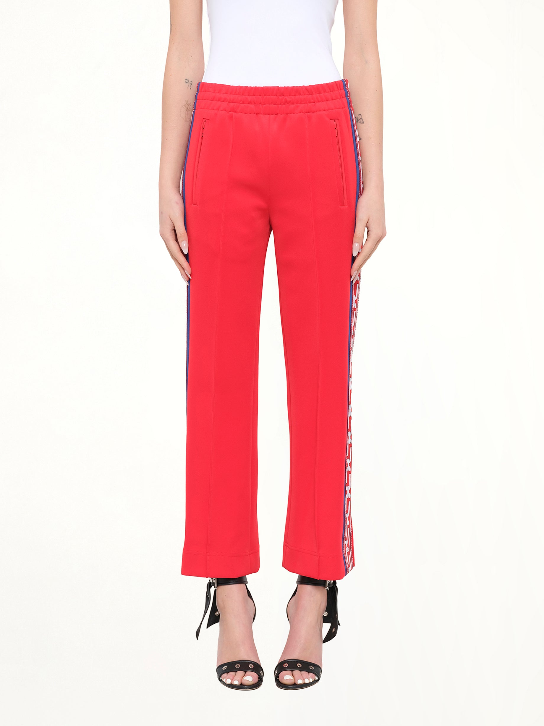 Image of a model wearing Pants. Product name - Marc Jacobs Track Pants in Red colour by brand - MARC JACOBS