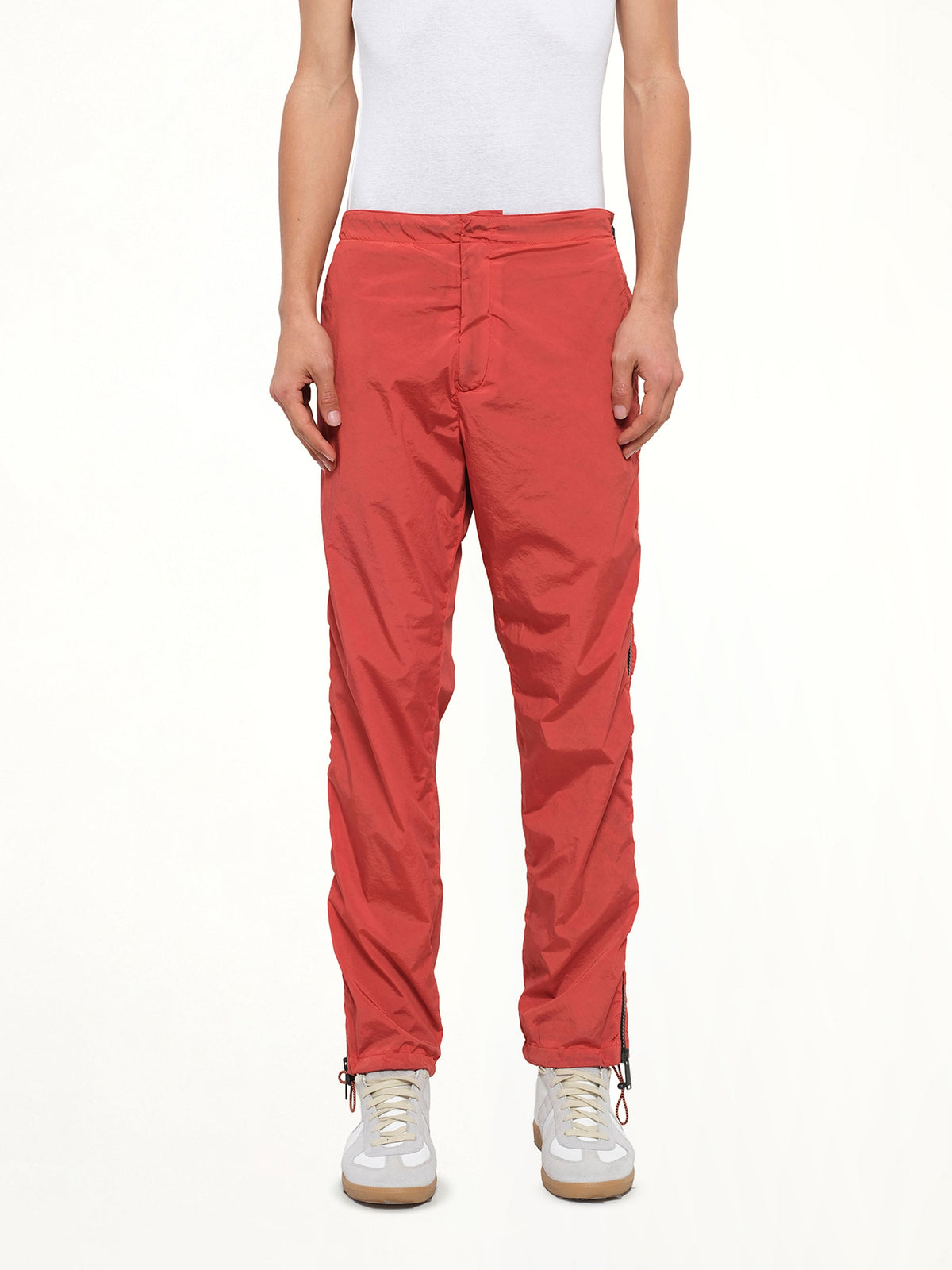 Image of a model wearing Pants. Product name - Side Zip Pants in Red colour by brand - HERON PRESTON