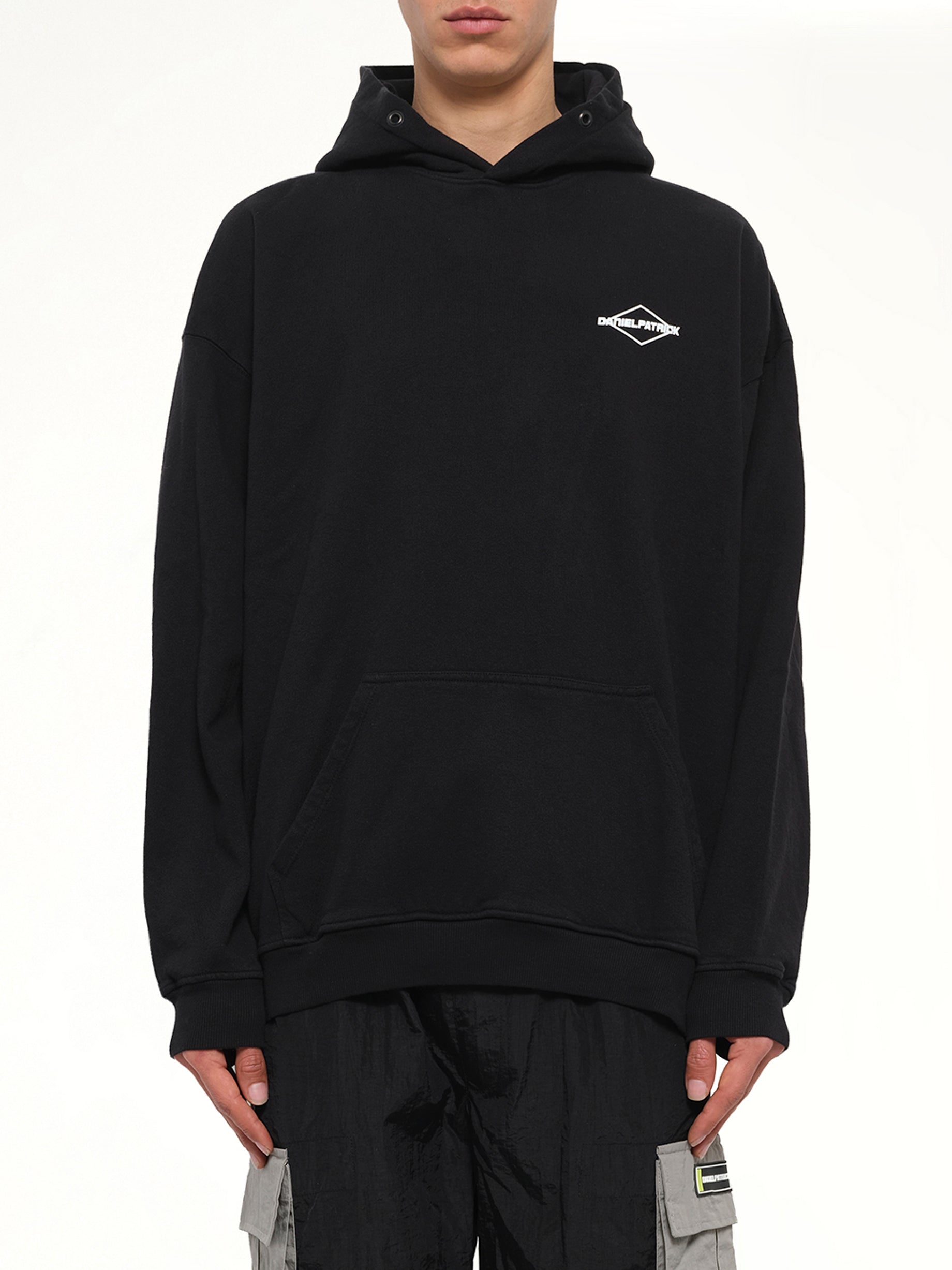Image of a model wearing Outerwear. Product name - Take Care Hoodie in Black colour by brand - DANIEL PATRICK