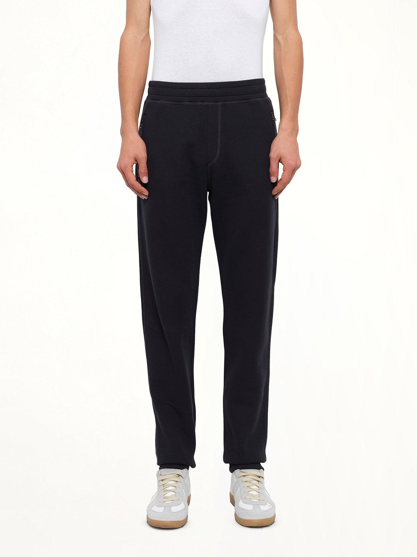Image of a model wearing Pants. Product name - Tech Jersey Slim Pants in Navy colour by brand - LANVIN