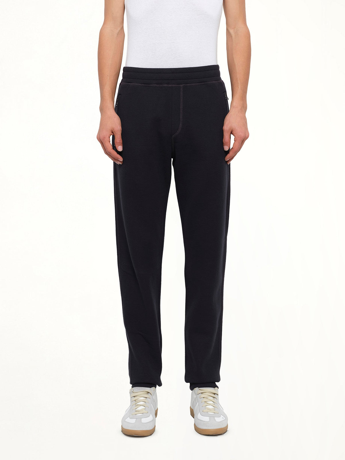Image of a model wearing Pants. Product name - Tech Jersey Slim Pants in Navy colour by brand - LANVIN