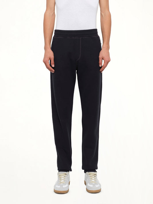 Image of a model wearing Pants. Product name - Tech Jersey Slim Pants in Navy colour by brand - LANVIN