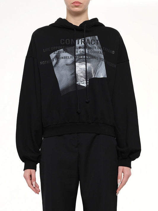 Image of a model wearing Outerwear. Product name - Juunj Oversize Hoodie in Black colour by brand - JUUNJ