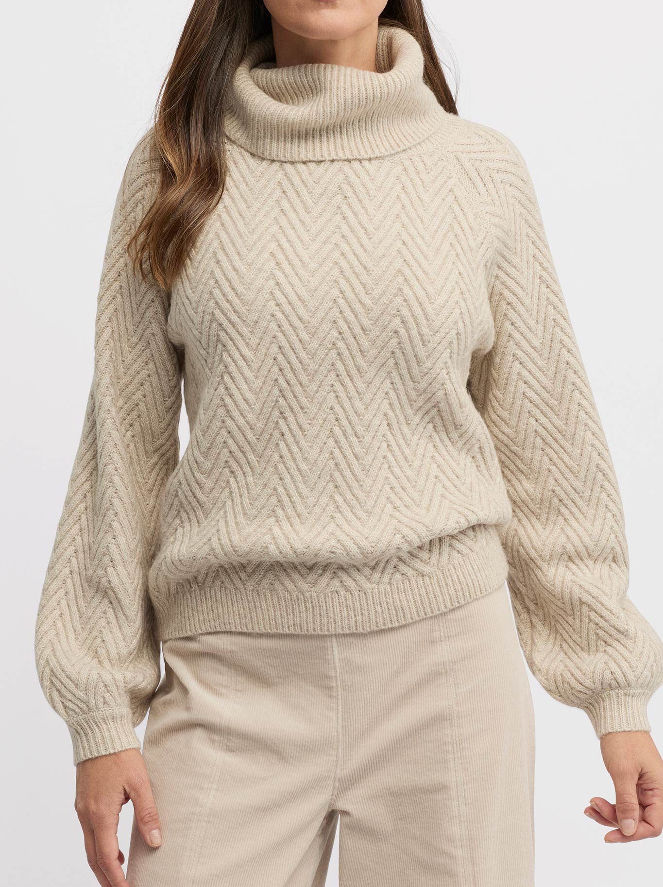 Image of a model wearing Outerwear. Product name - Yarra Trail Hudson Knit in Almond colour by brand - Yarra Trail