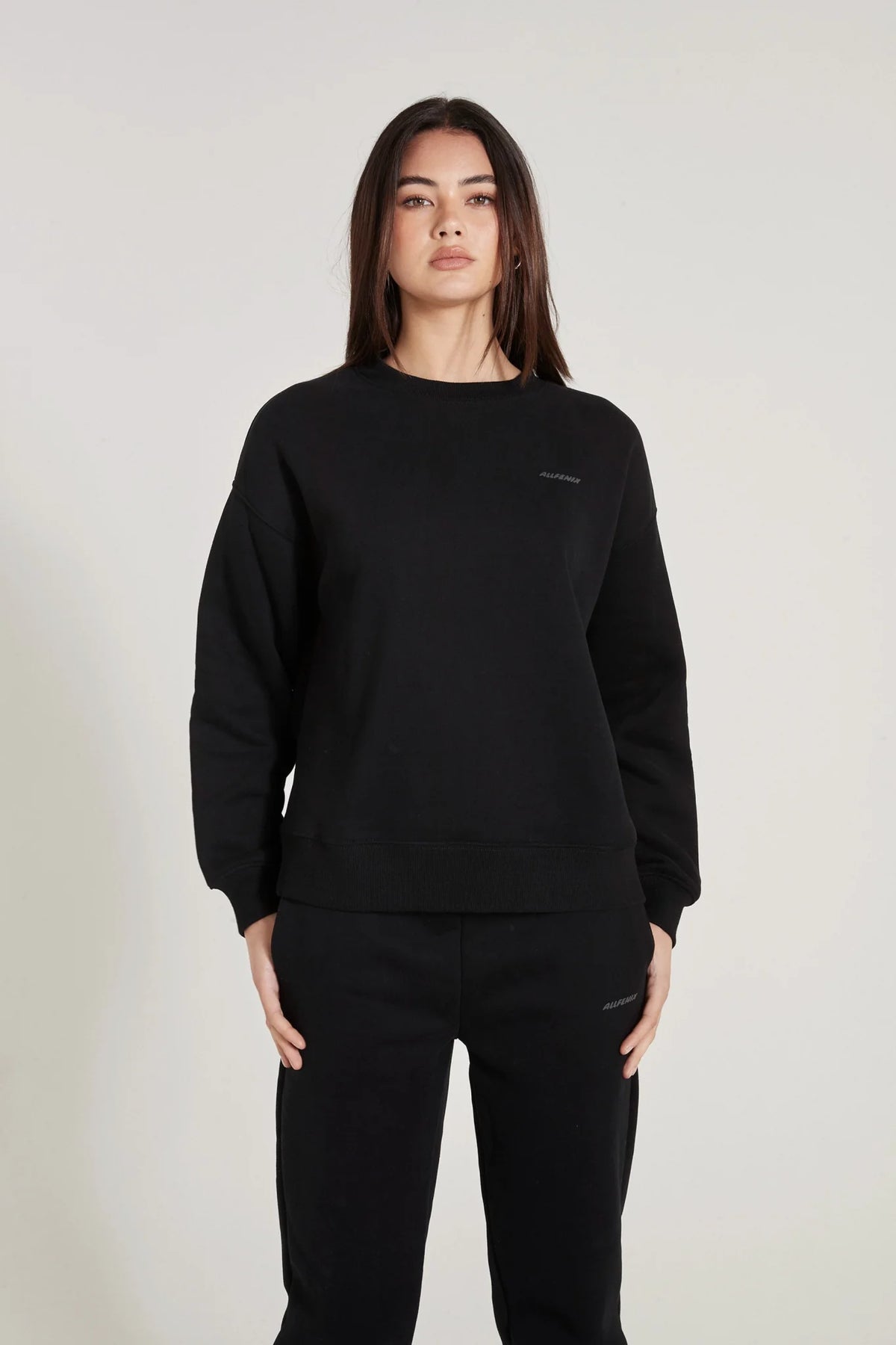 Image of a model wearing Outerwear. Product name - ALLFENIX Signature Crew Sweater in Black colour by brand - All Fenix