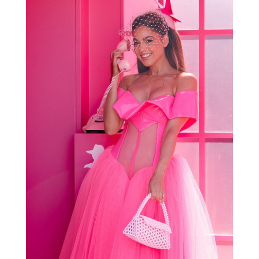 Image of a model wearing Tops. Productname: AMRITA Bead Top Handle in colour by brand - Olga Berg