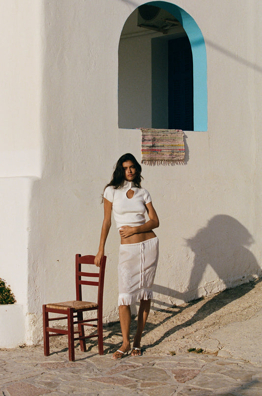 Image of a model wearing Skirts. Product name - Andie Skirt in White colour by brand - With Jéan