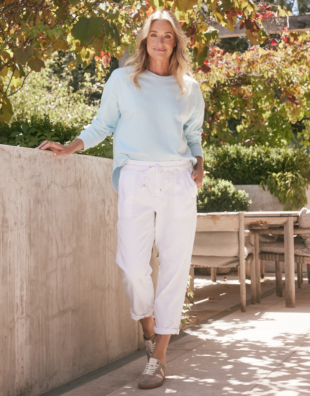 Image of a model wearing Pants. Product name - Beach Comber Pant White in White colour by brand - White & Co.