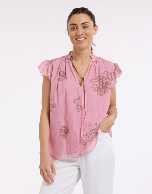 Image of a model wearing Tops. Product name - Frill Neck Top Choc/Pink in Choc/Pink colour by brand - Beautiful Stories