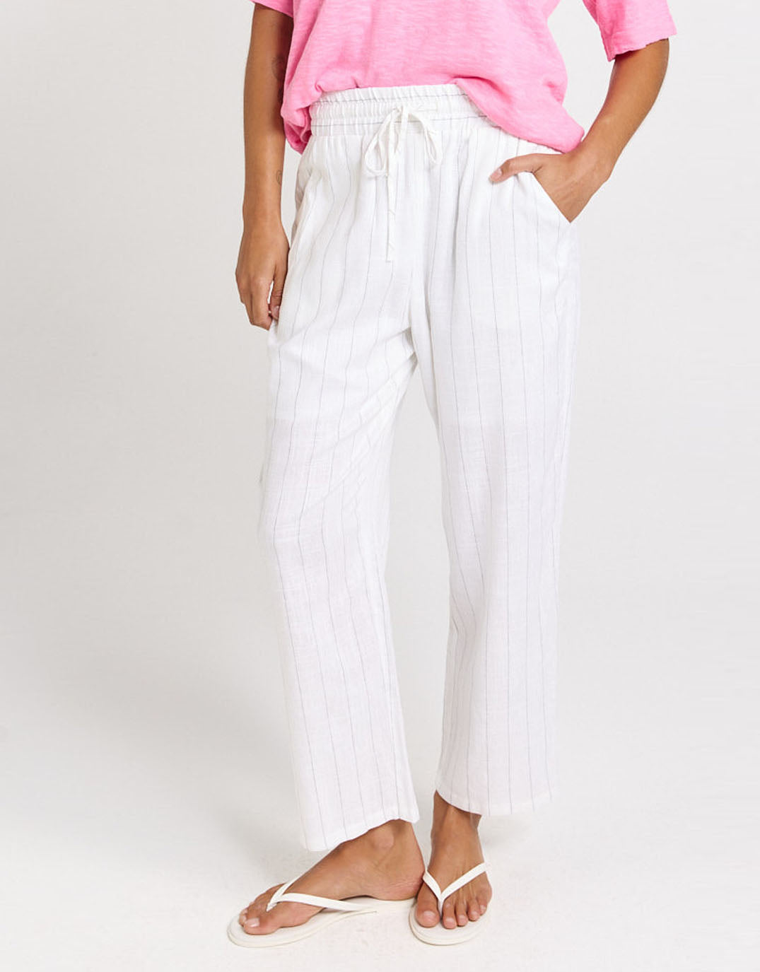 Image of a model wearing Pants. Product name - Palm Relax Pant White/Black Stripe in White/Black Stripe colour by brand - Betty Basics