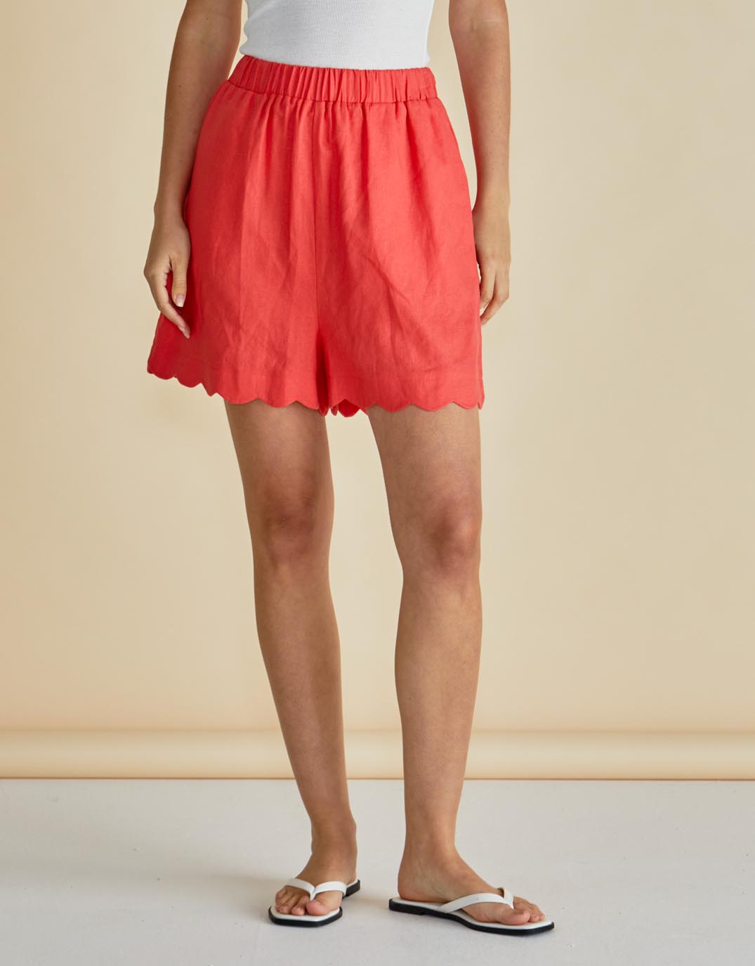 Image of a model wearing Shorts. Product name - Seraphina Short Red in Red colour by brand - Betty Basics