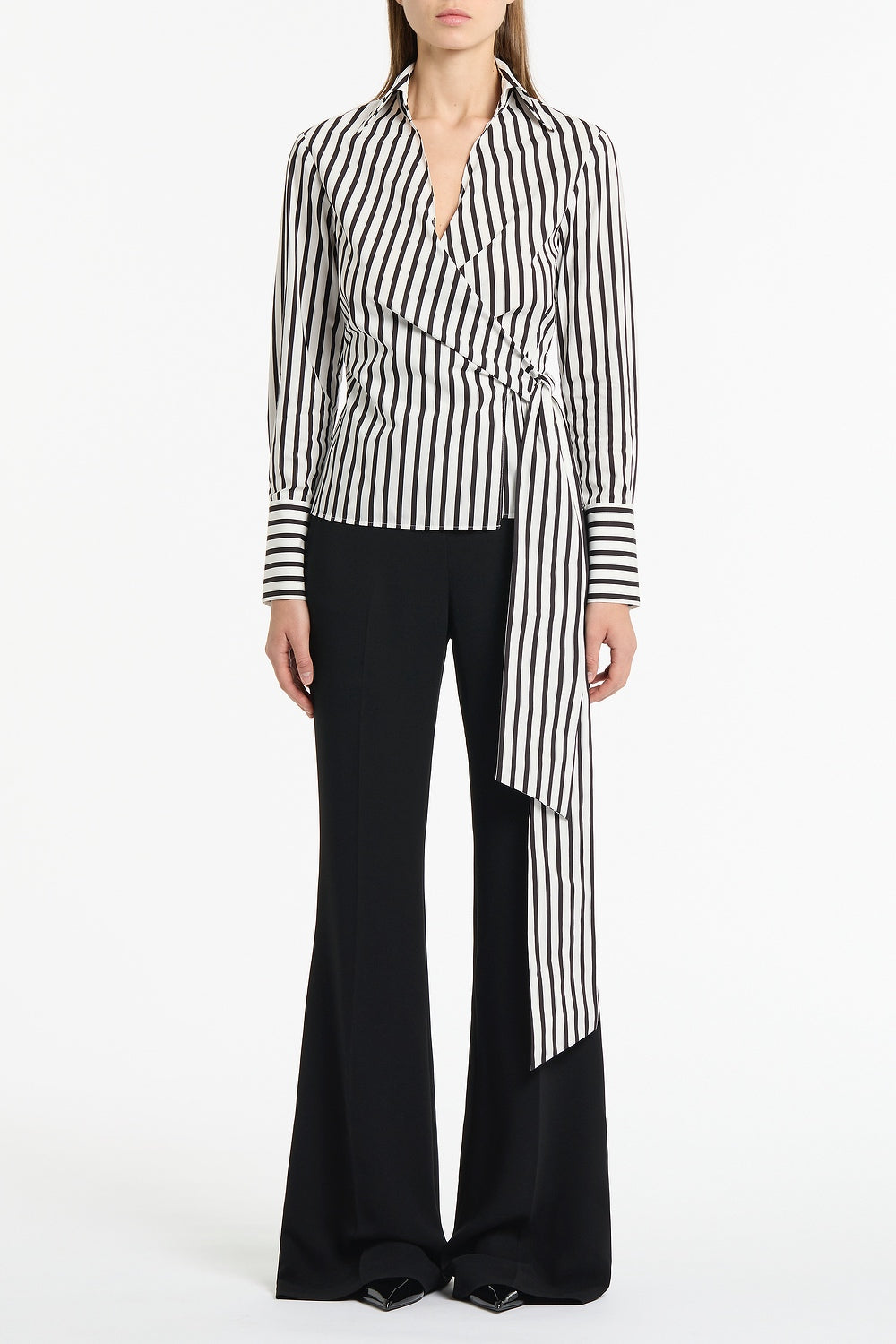Image of a model wearing Tops. Product name - Black And White Stripe Cotton Wrap Top in Black colour by brand - Carla Zampatti