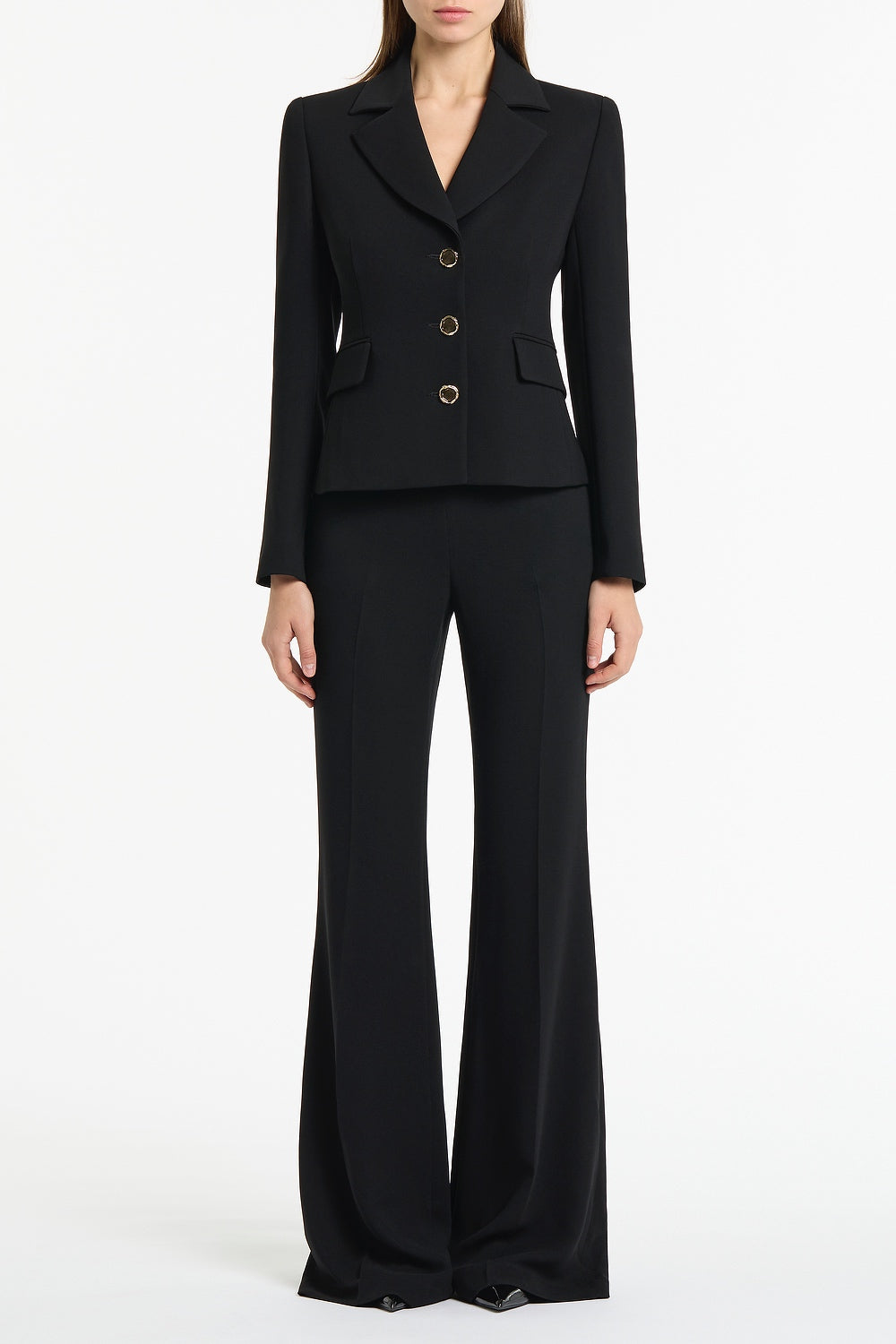 Image of a model wearing Pants. Product name - Black Crepe Bootleg Pant in Black colour by brand - Carla Zampatti