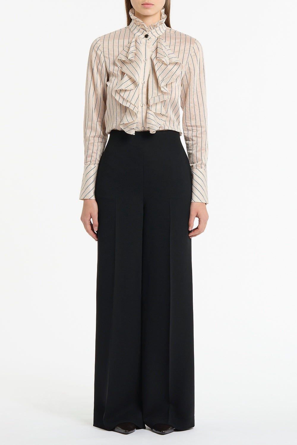 Image of a model wearing Pants. Product name - Black Crepe High Waisted Wide Leg Pant in Black colour by brand - Carla Zampatti