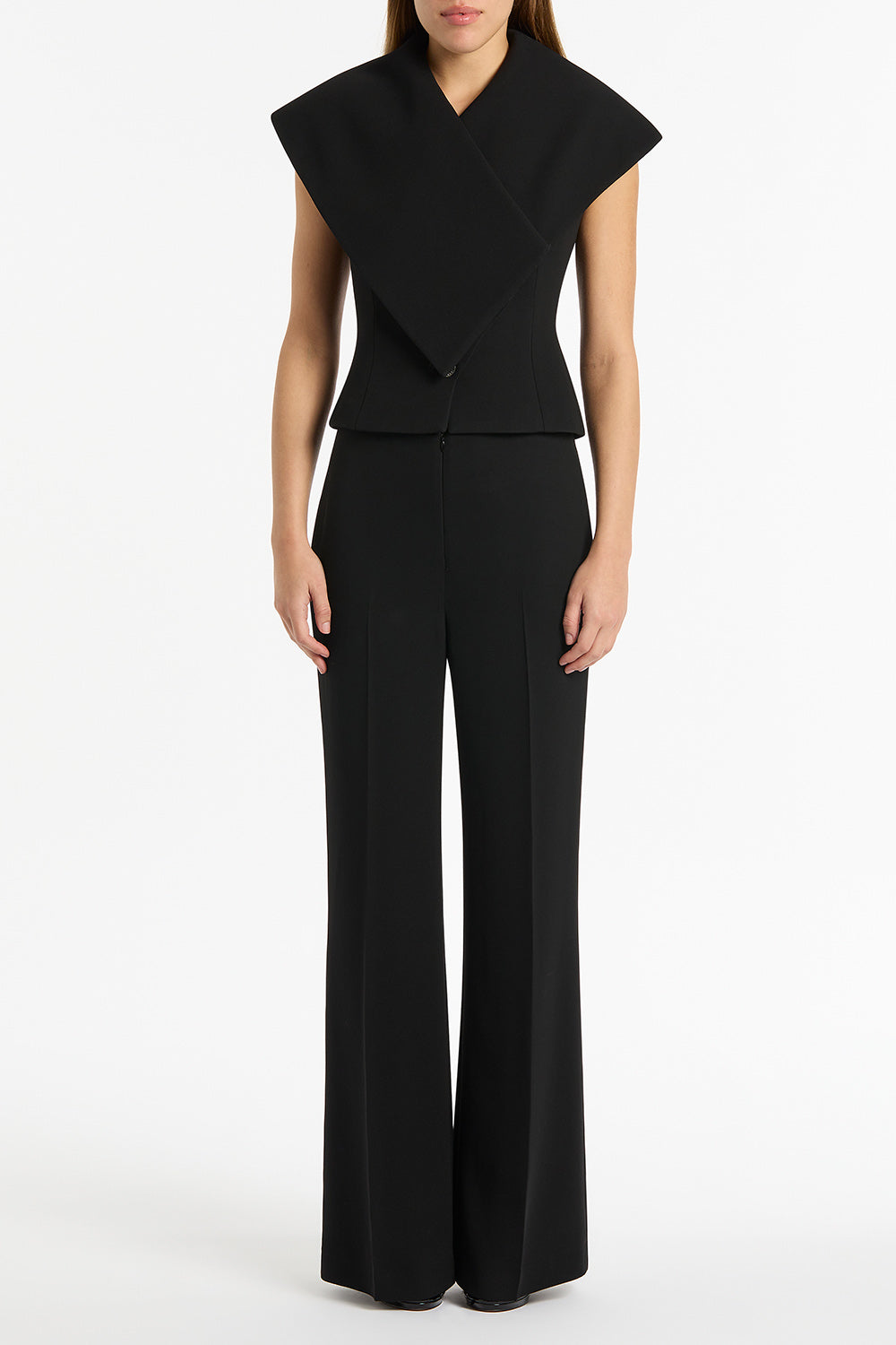 Image of a model wearing Pants. Product name - Black Crepe Low Waist Pant in Black colour by brand - Carla Zampatti